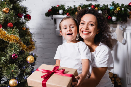 mother and toddler girl with christmas present