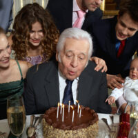 Senior Adult man blowing out candles